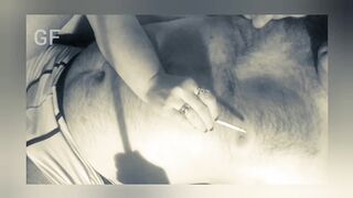 He smokes a cigarette and licks his lover's nipples